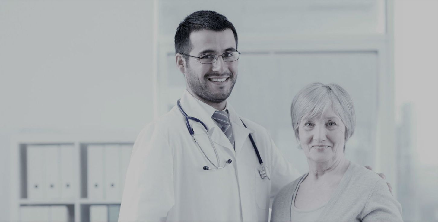 A doctor and a patient are standing next to each other in a hospital room.