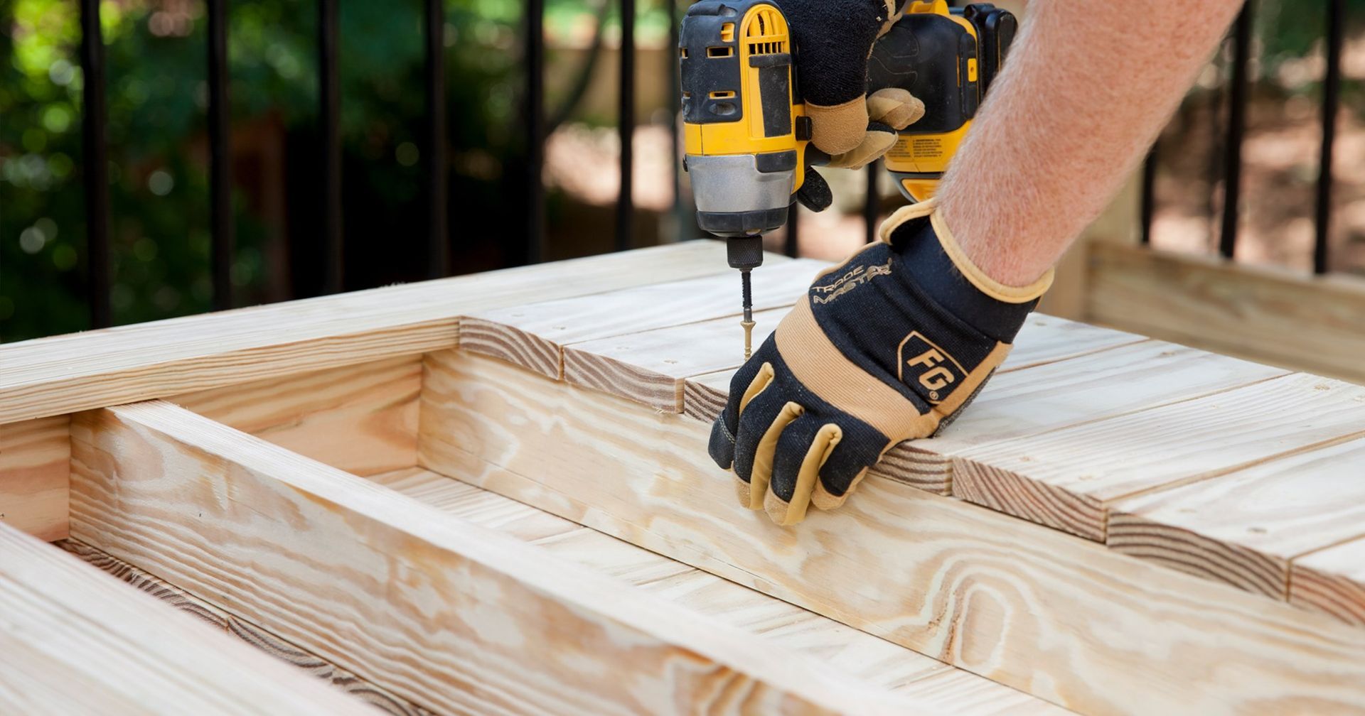 A person is using a drill to drill a hole in a piece of wood.