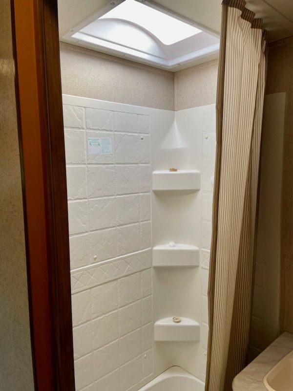 A bathroom with a sink, toilet, and mirror.