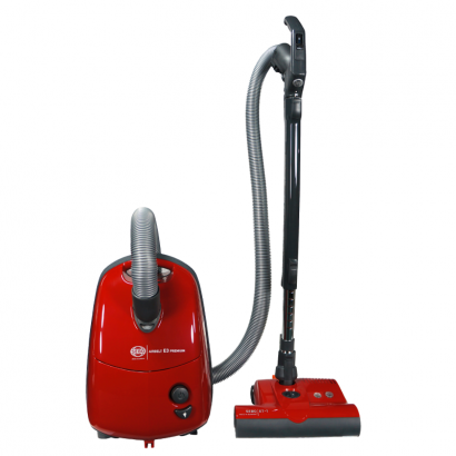 Red canister vacuum with hose, wand, and floor brush, on white background.