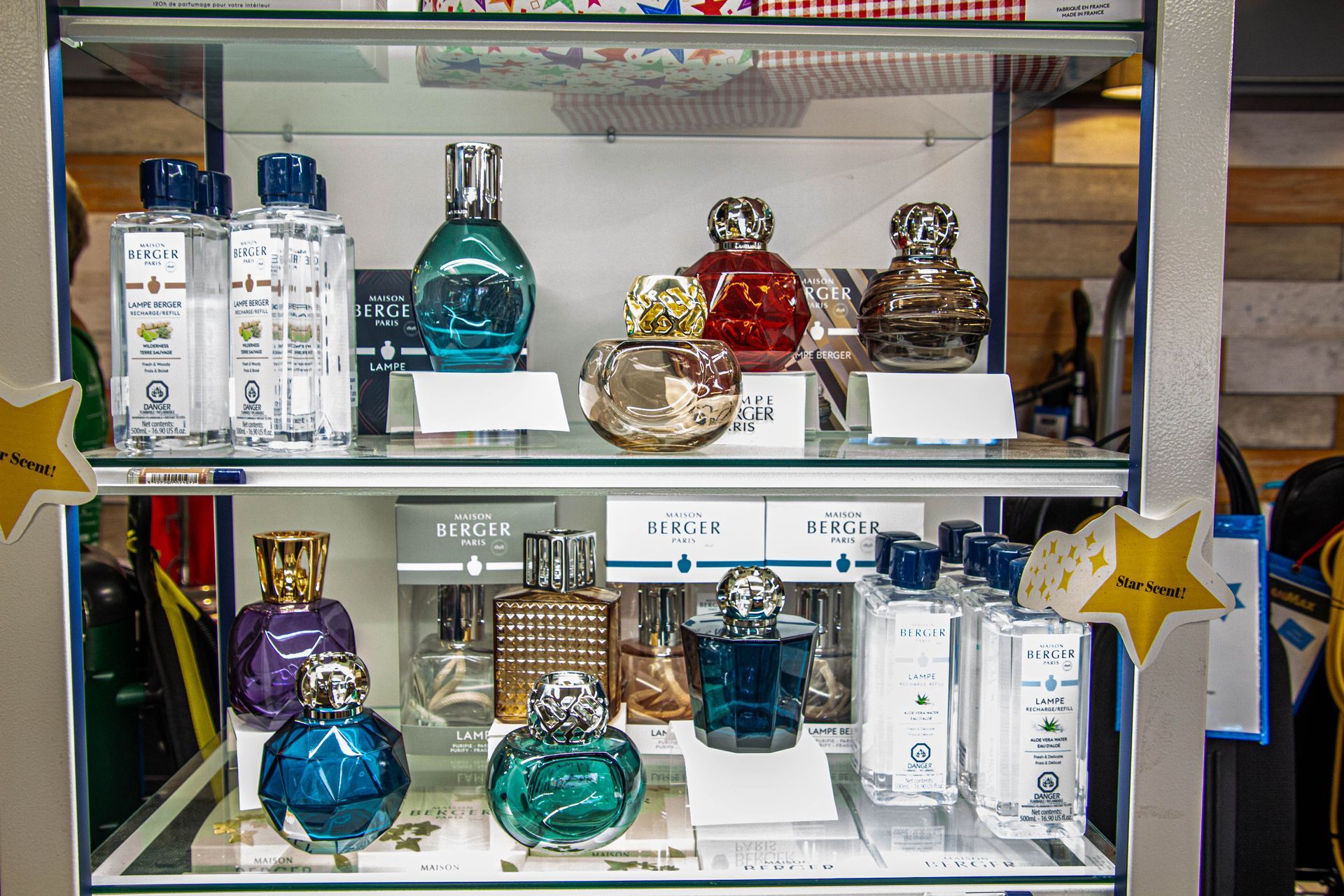 Glass display case with various colorful perfume bottles.