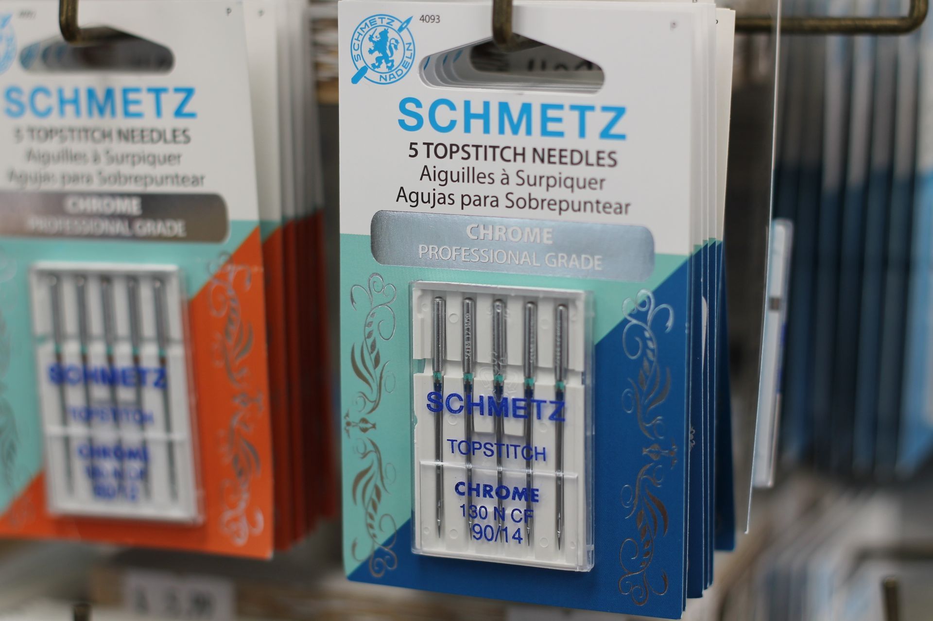 Packages of Schmetz Topstitch needles on display.