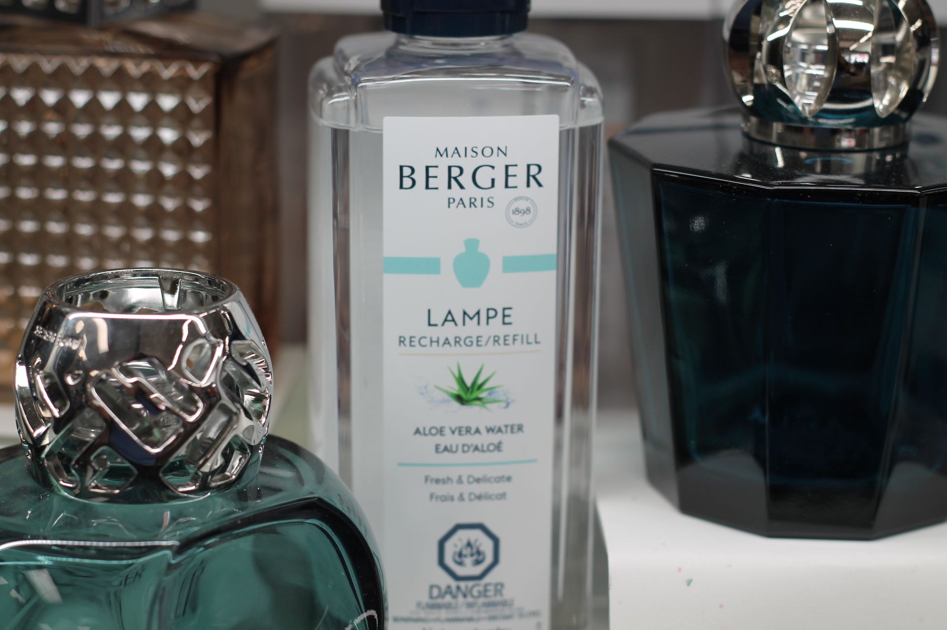 Bottles of Maison Berger Paris lamp fragrance, including Aloe Vera Water.