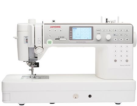 White Janome sewing machine with digital display, buttons, and various dials.