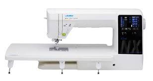 White Juki sewing machine with an extended table and touch screen controls.