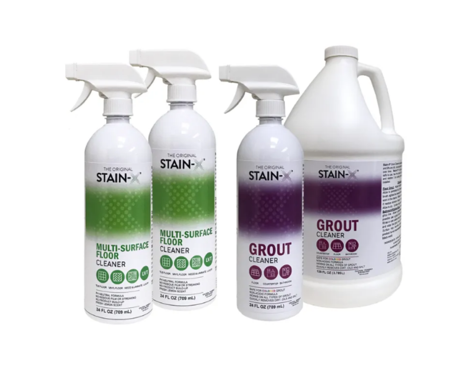 Four bottles of Stain-X cleaners: two green-labeled floor cleaners, one purple-labeled grout cleaner, and a gallon jug of grout cleaner.