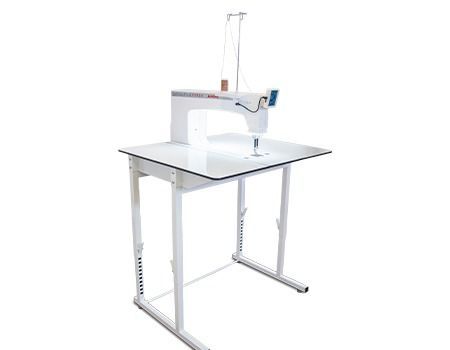 White quilting machine on an adjustable white table, against a white background.