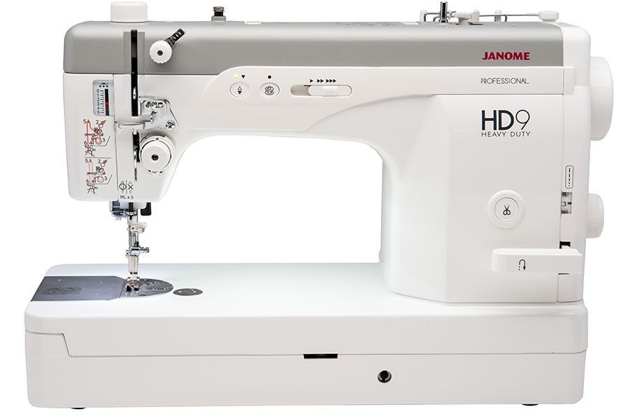 White Janome HD9 sewing machine. Gray accents, bobbin area, thread spool, and needle.