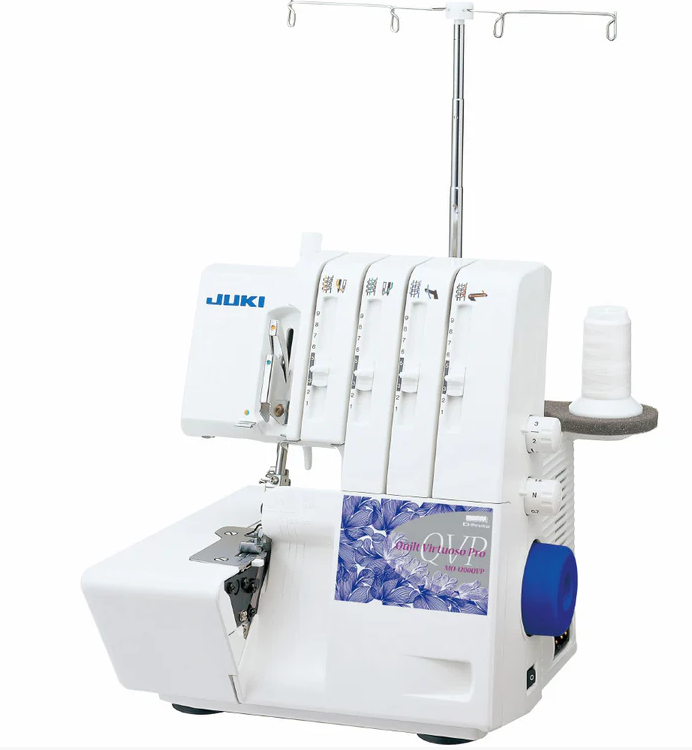 White Juki serger sewing machine with four thread spools and a blue handwheel.
