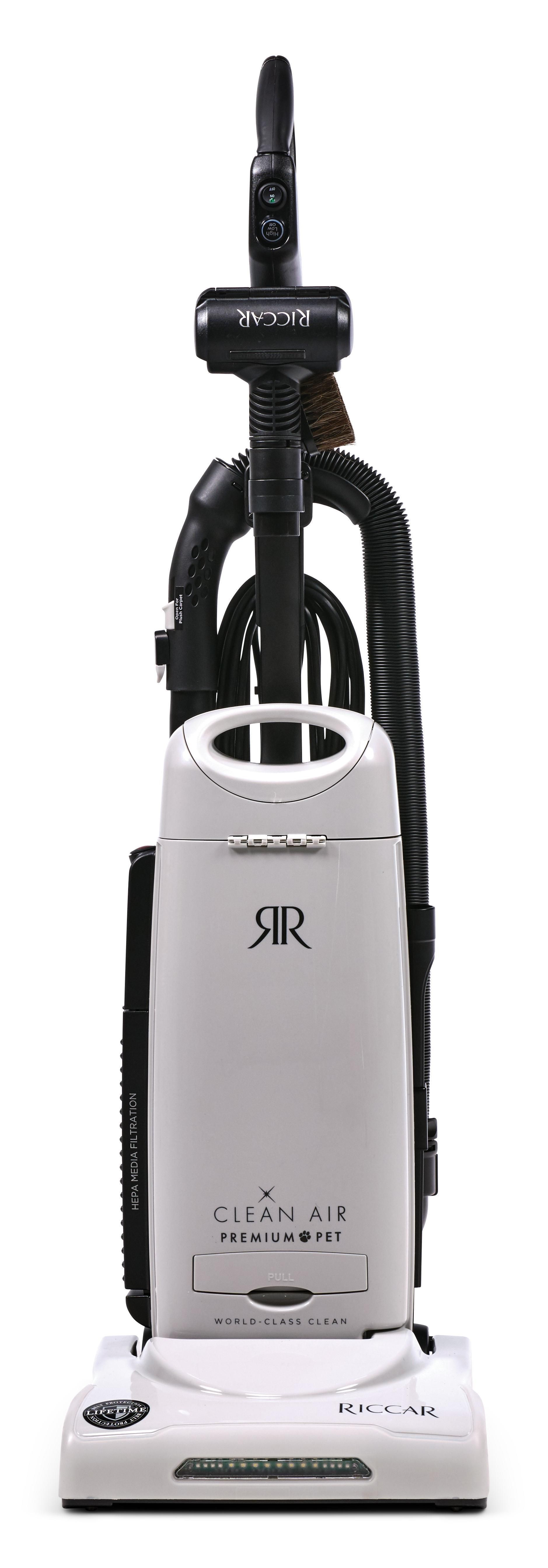 A white upright vacuum cleaner with a black cord and handle, shown standing against a plain white background.