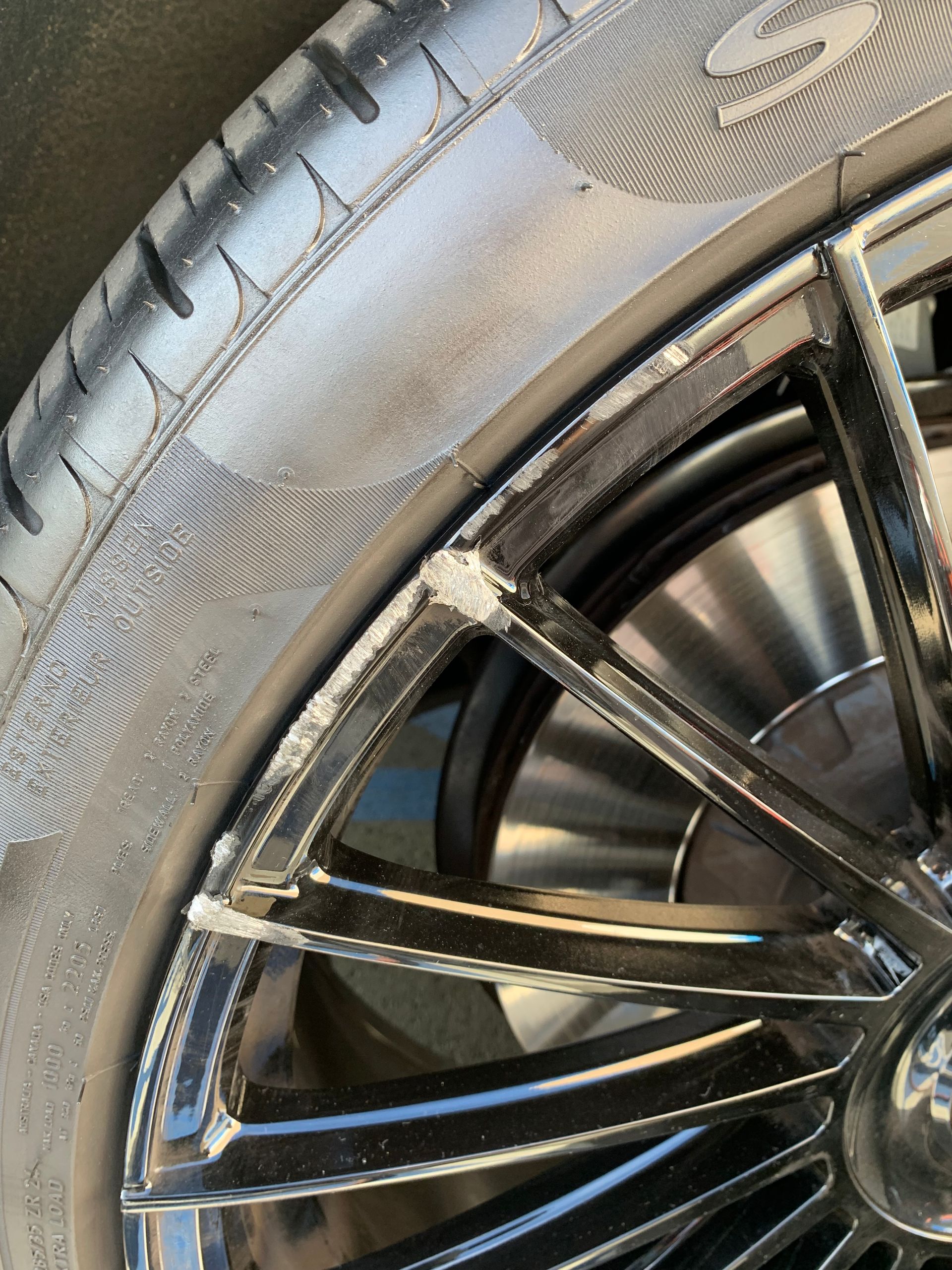 Close-up of a black tire and alloy wheel on a car, showing tread and rim details.