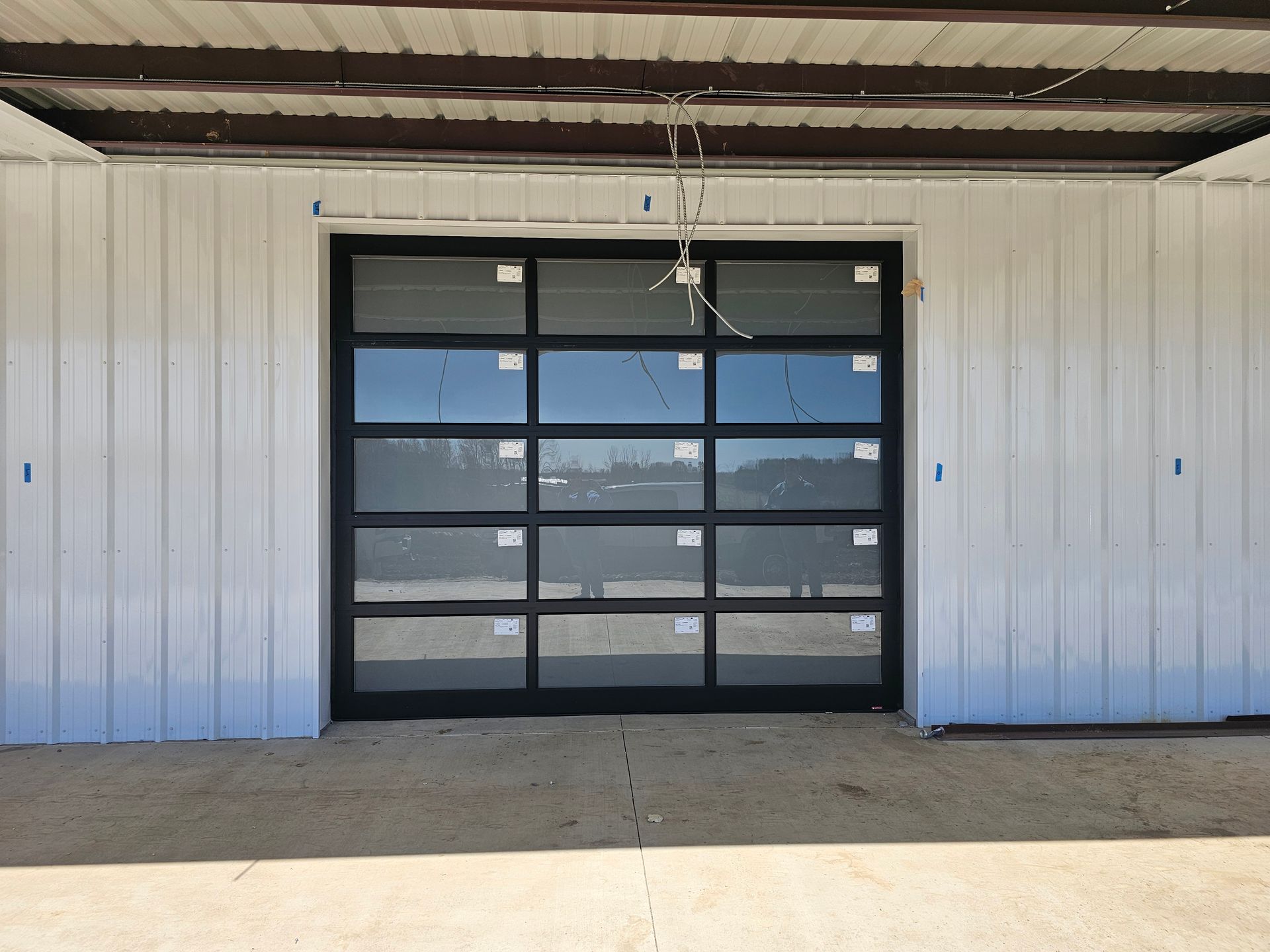A white building with a black garage door