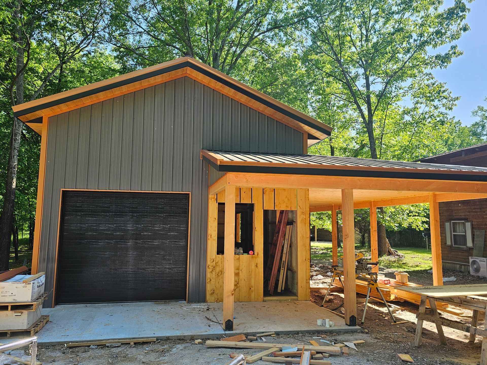 A garage is being built in the backyard of a house.