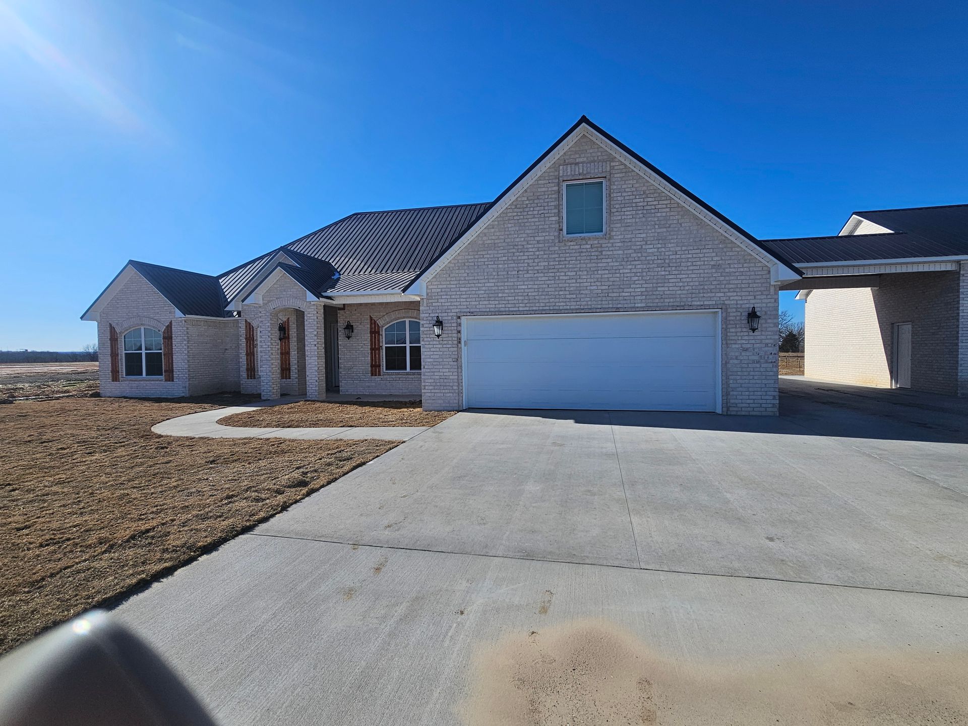 A large brick house with a white garage door