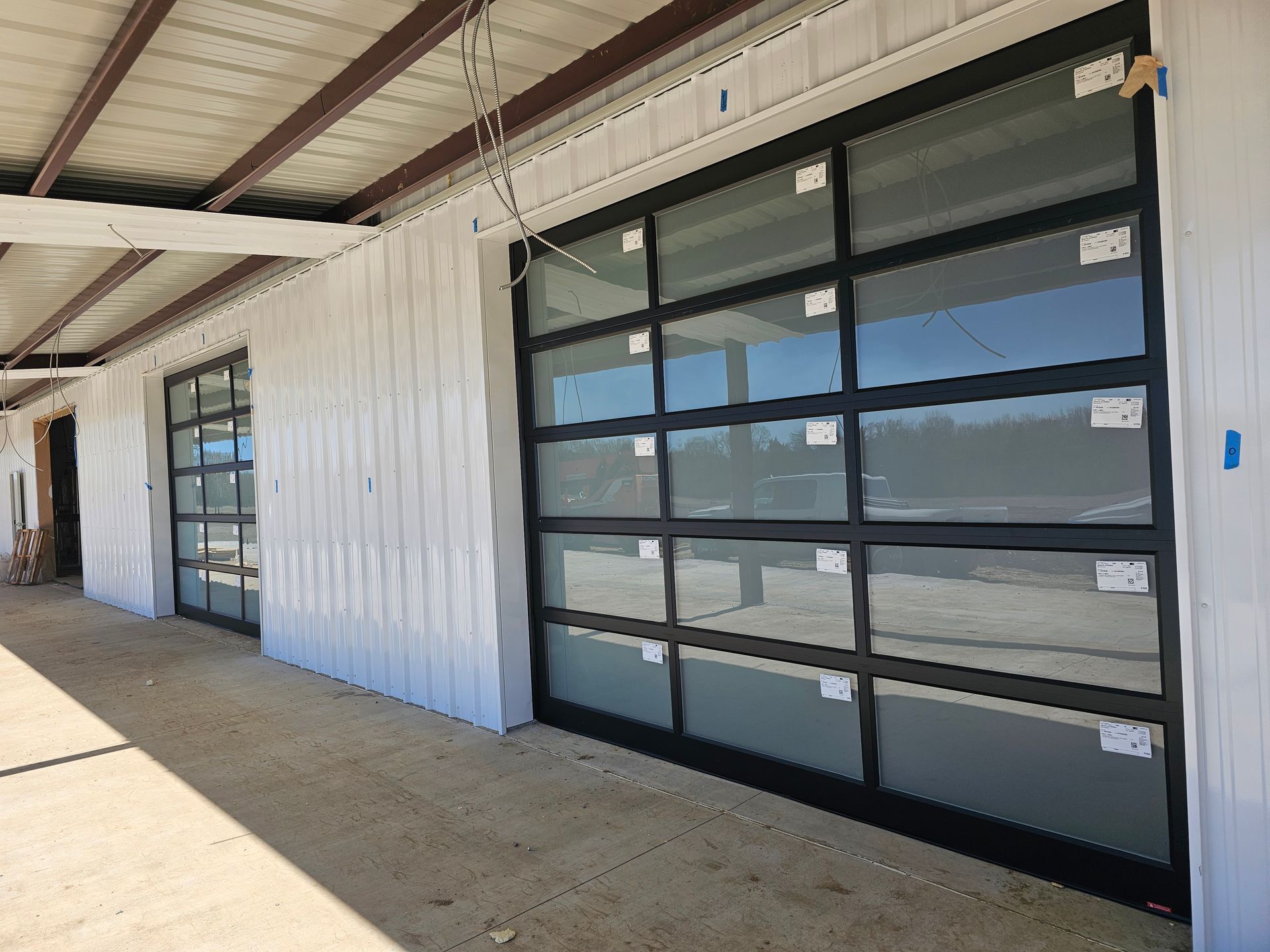 A large garage door is being installed on the side of a building.