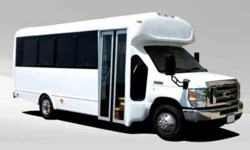 White shuttle bus parked on a gray background, doors open.