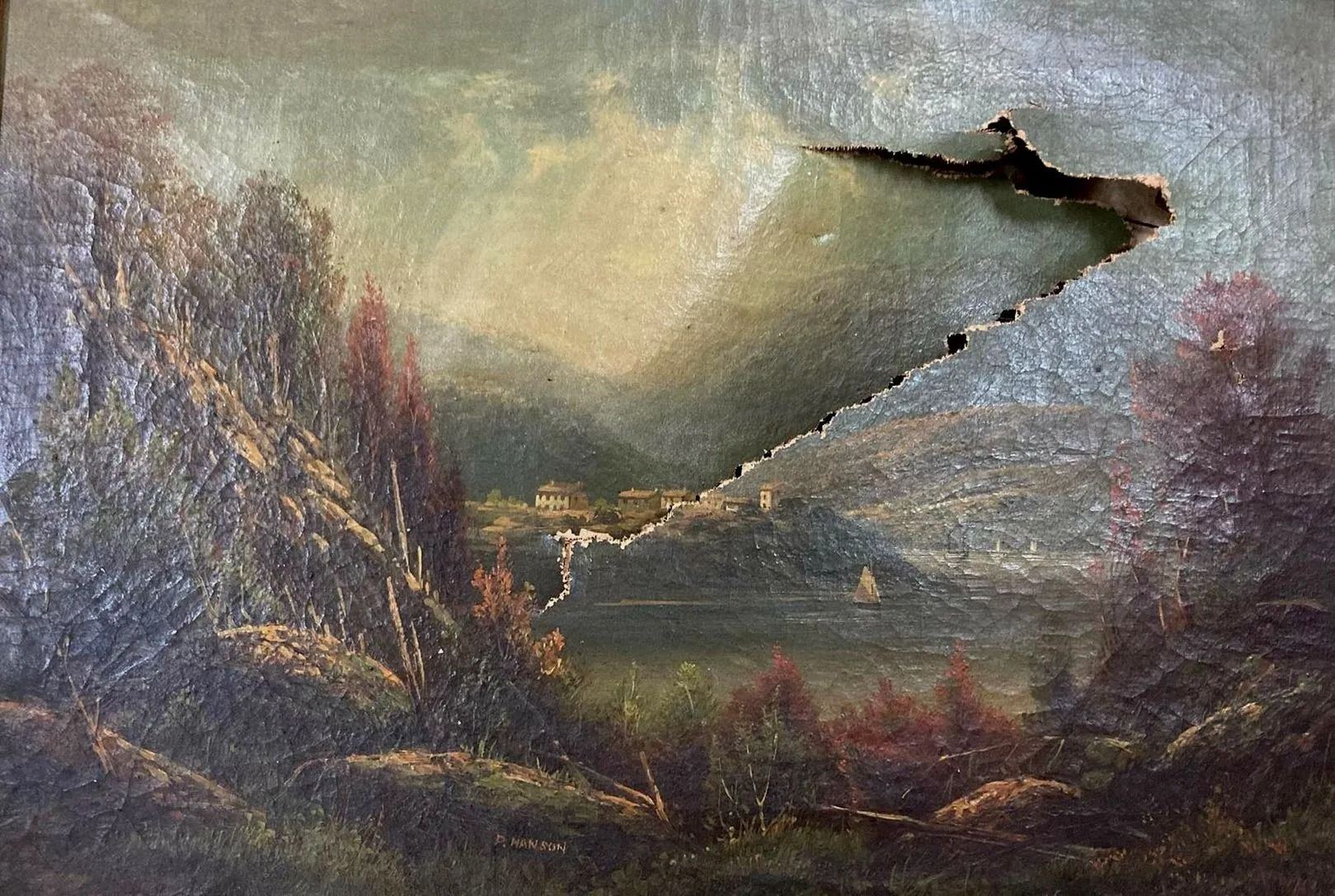 Oil painting of a landscape with a large tear across the center. Green trees, a lake, and a distant village are visible.