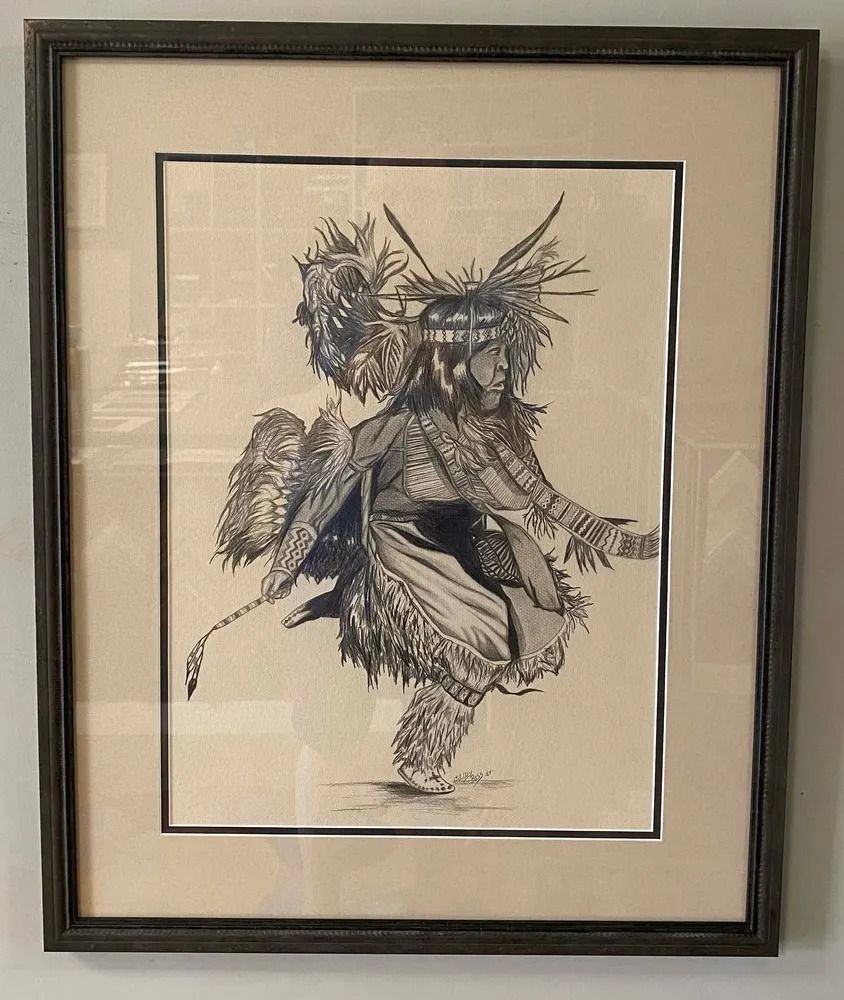 Framed pencil drawing of a Native American dancer in traditional regalia, performing a ceremonial dance..