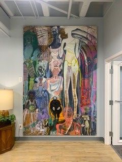 Large, colorful abstract painting on a wall in an office setting.