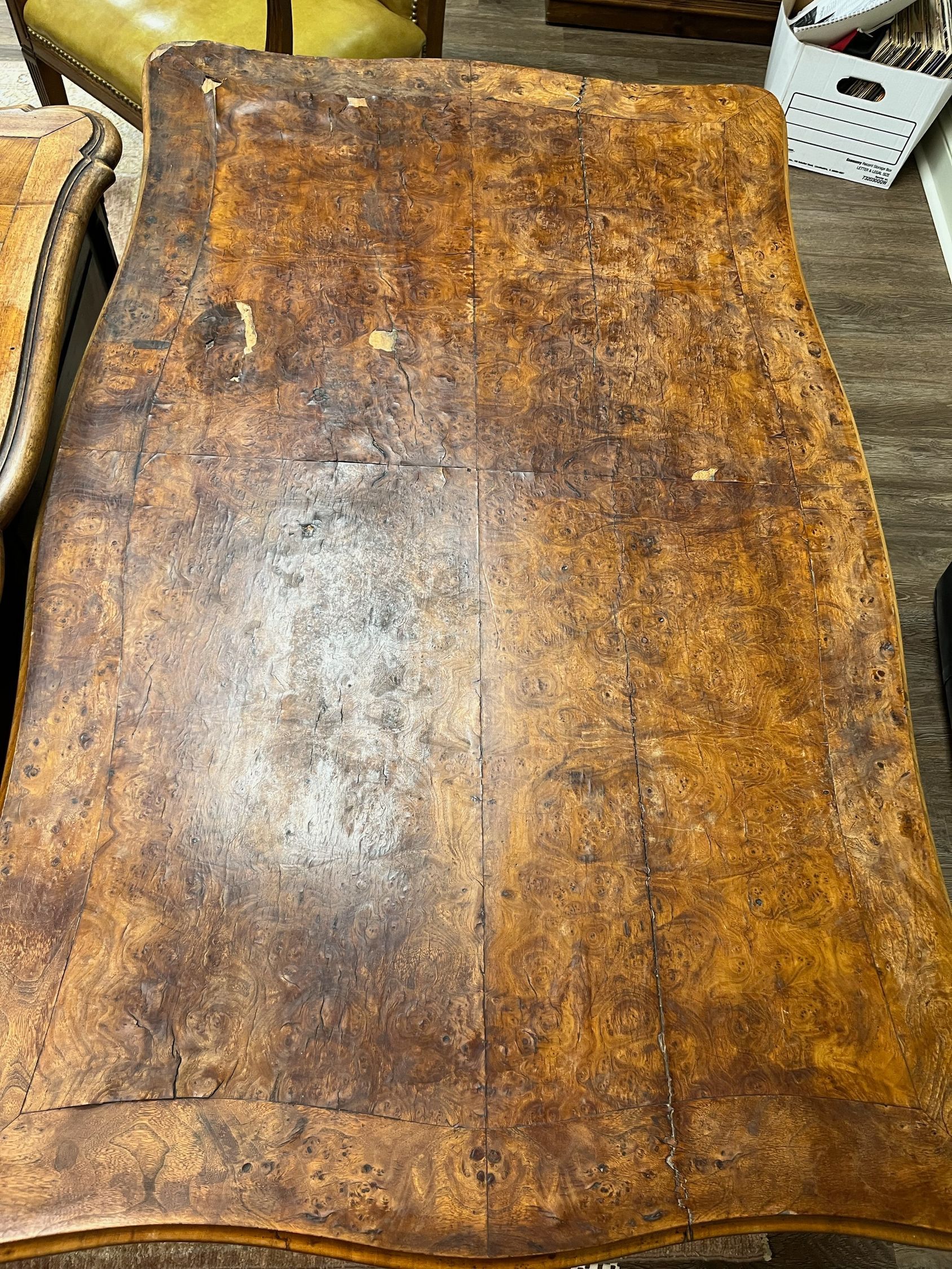 Top-down view of a rectangular, brown leather desk with a worn, distressed appearance.