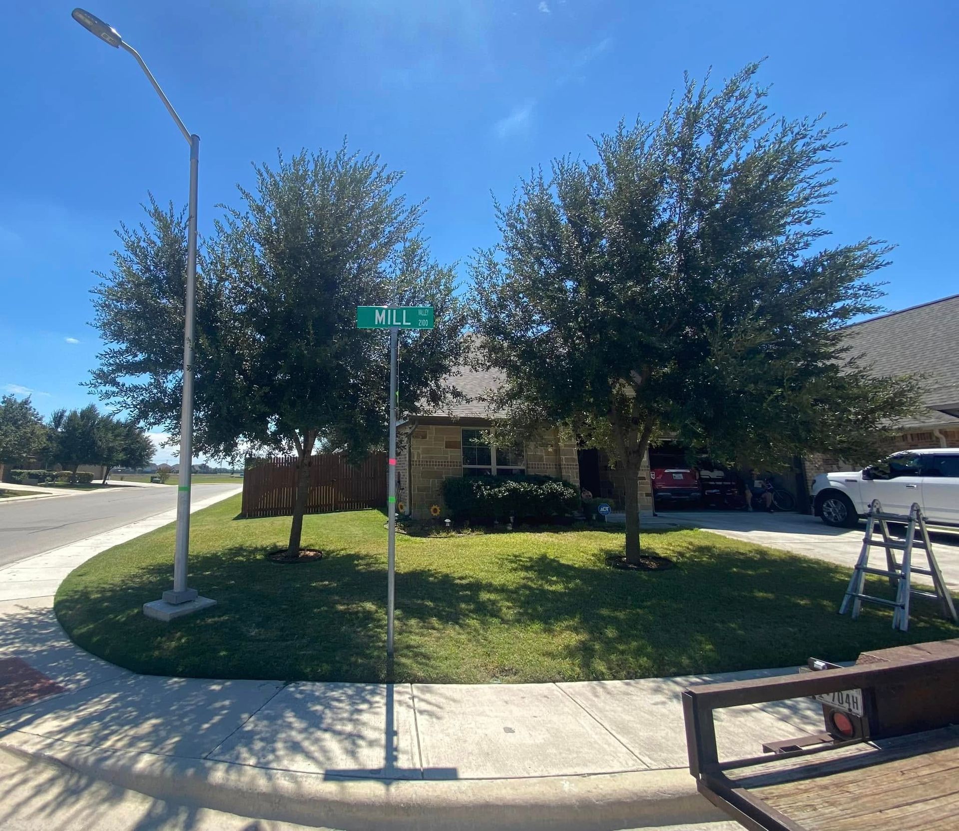A house with a green street sign in front of it