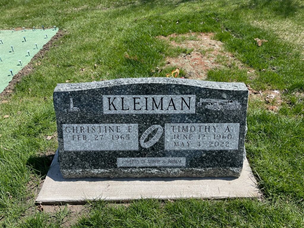A gravestone in a cemetery with the name Kleiman on it