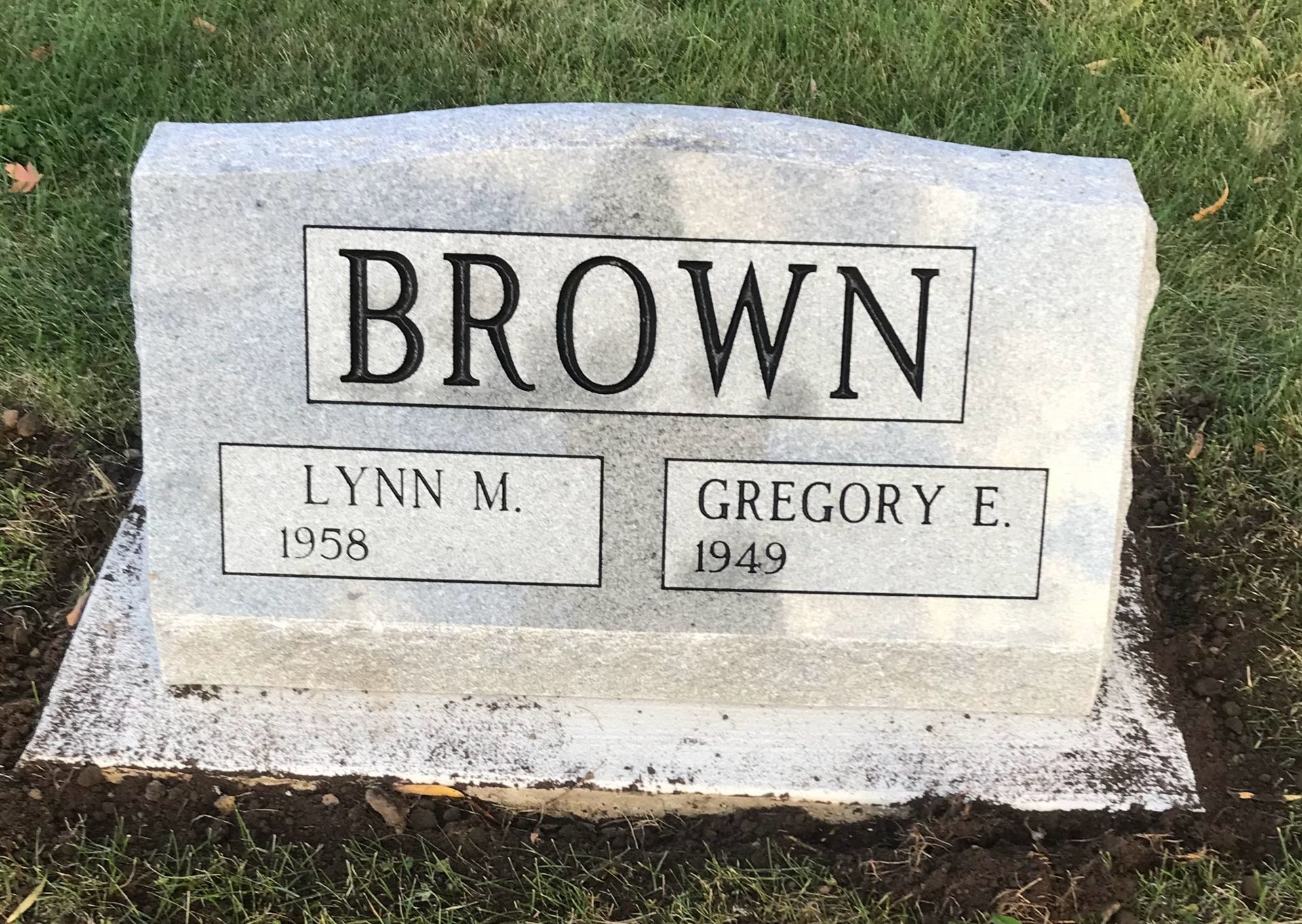 A gravestone for Lynn M. Brown and Gregory E. Brown in a cemetery