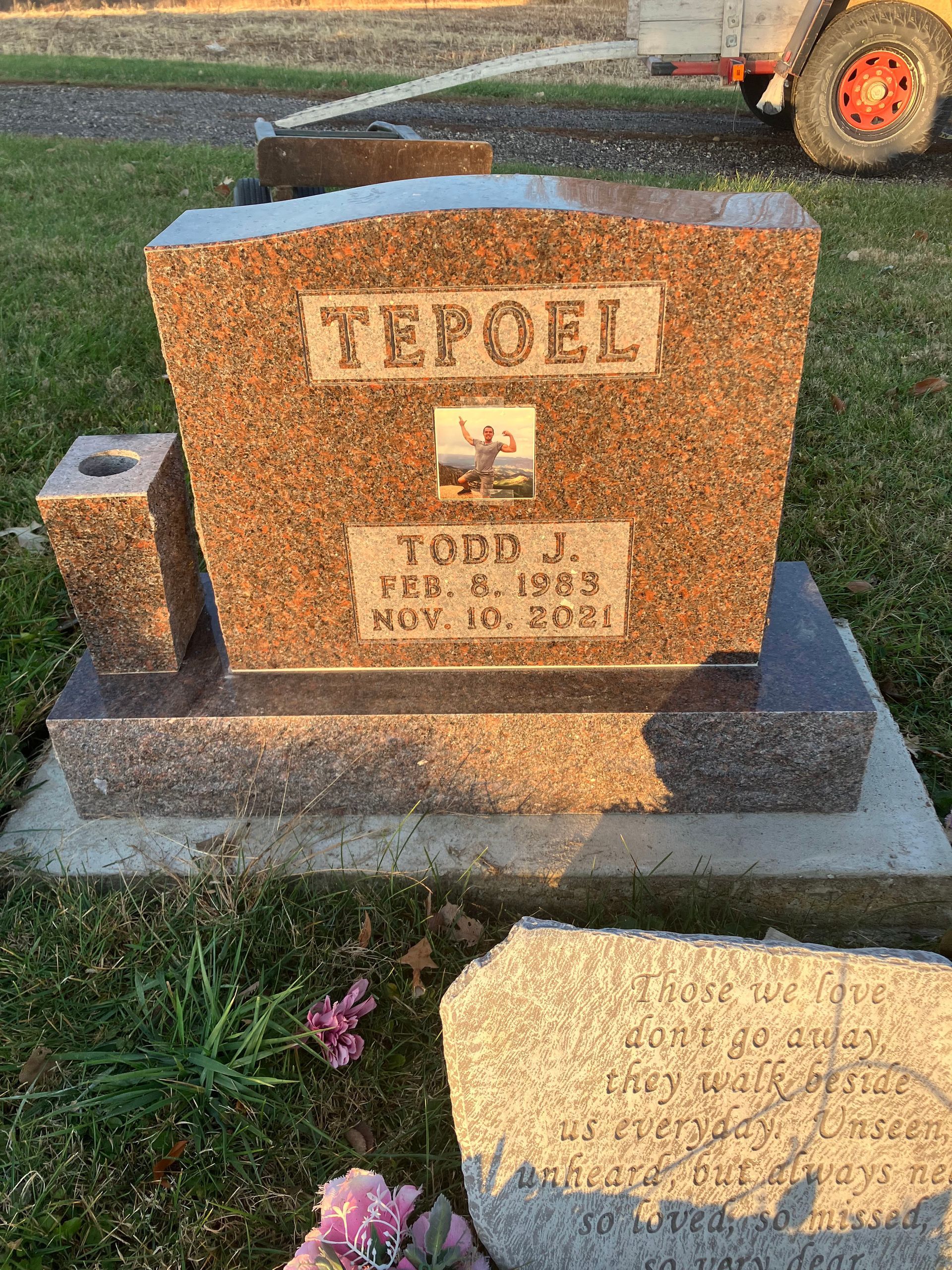 A gravestone in a cemetery with a picture of a deer on it