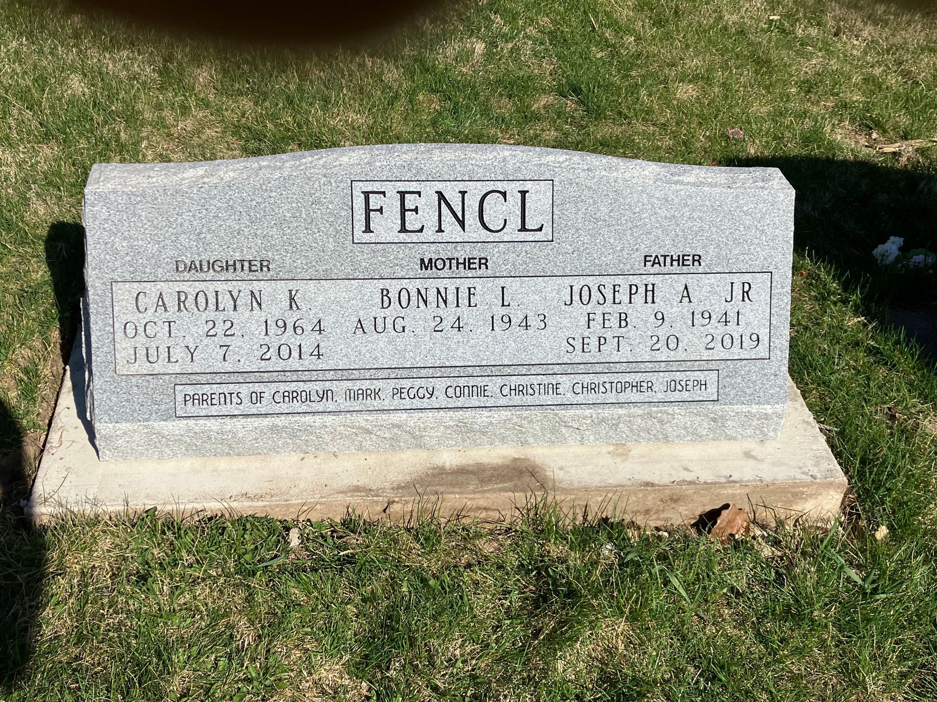 A gravestone in a cemetery with the name Fencl on it