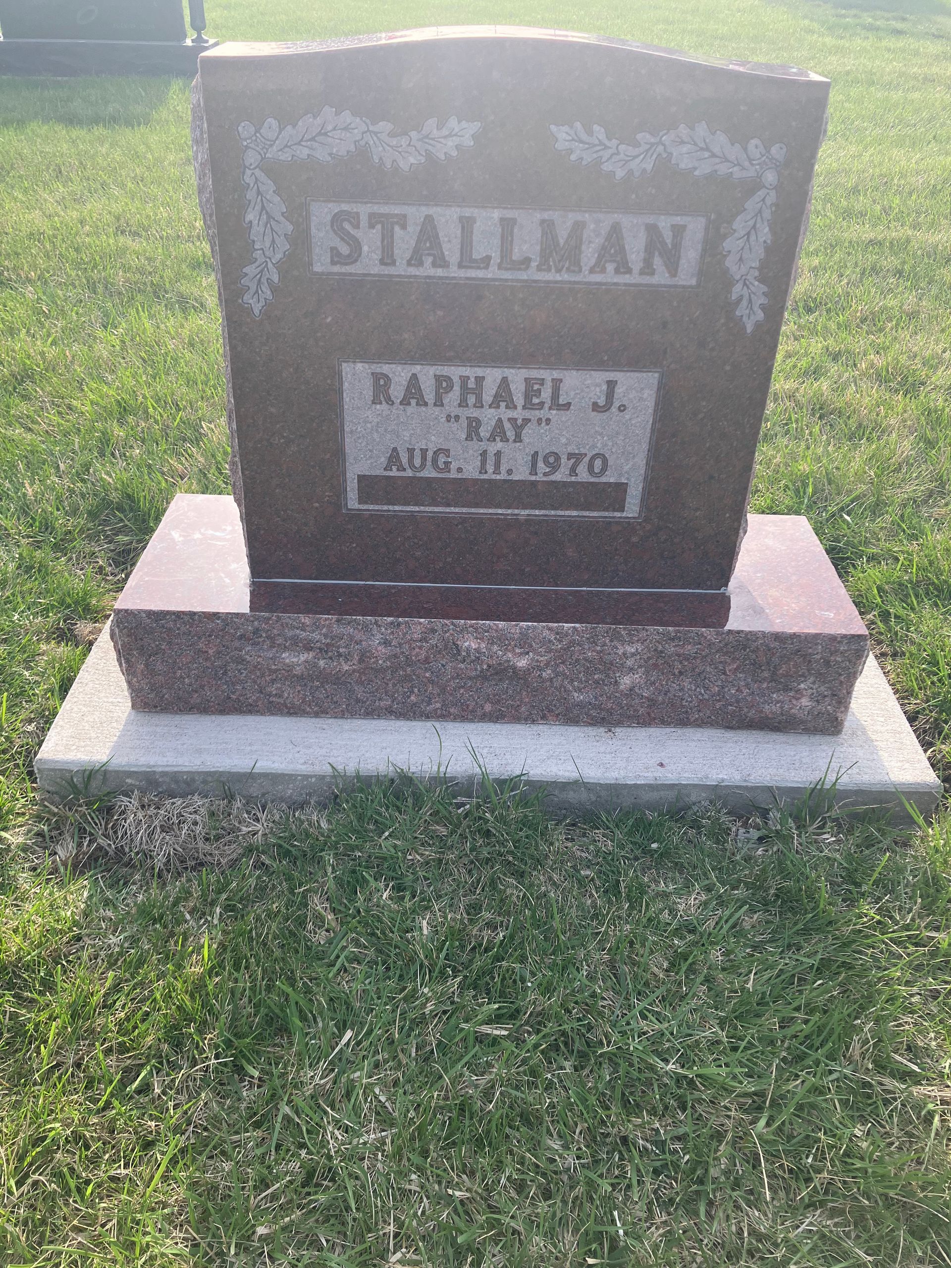 A gravestone for a man named Stallman in a cemetery