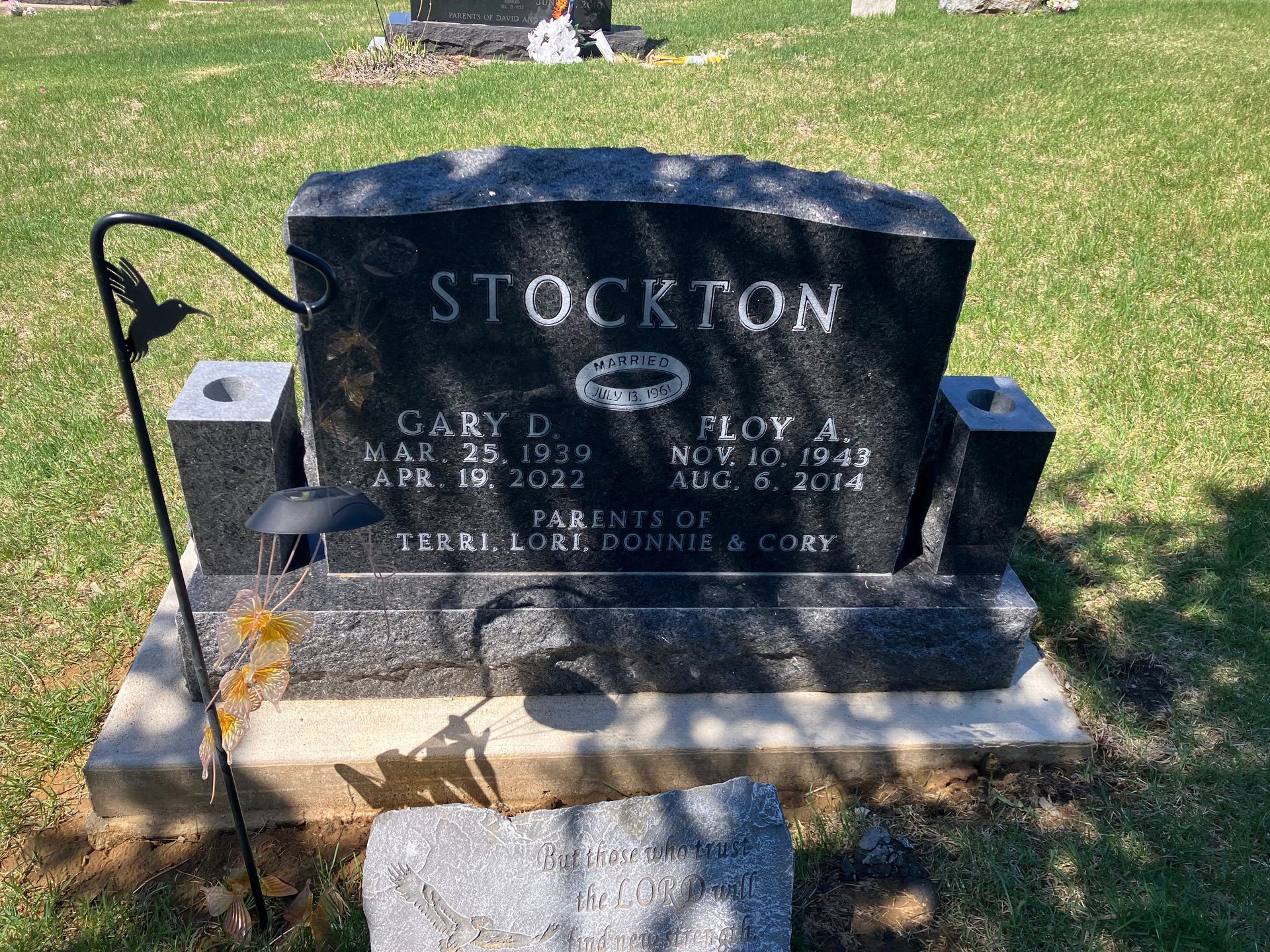 A black gravestone with the name Stockton on it in a cemetery