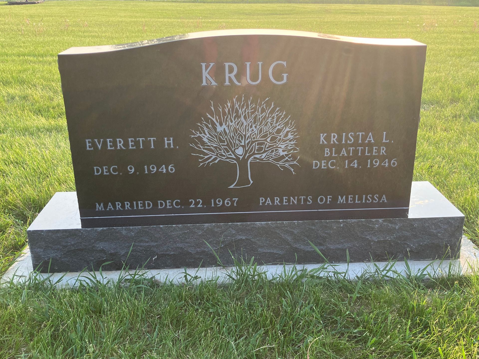 A black gravestone with the name Krug on it