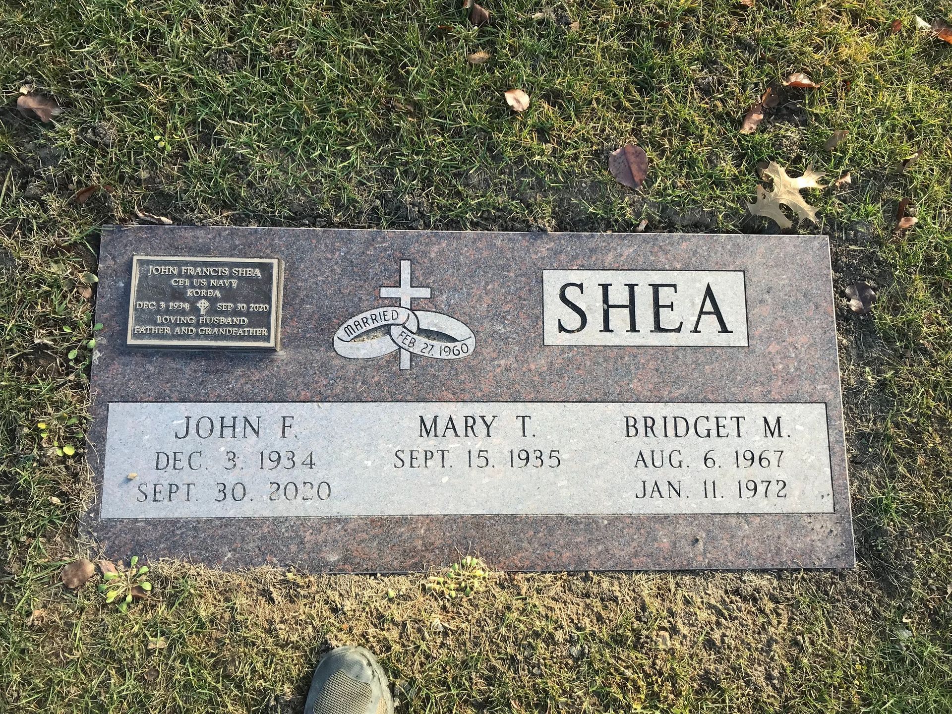 A gravestone in a cemetery with the name Shea on it