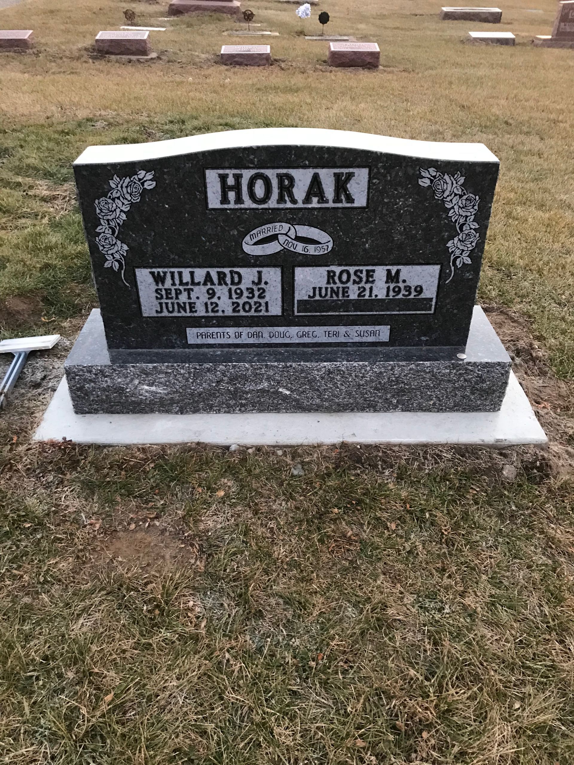 A gravestone in a cemetery with the name horak on it