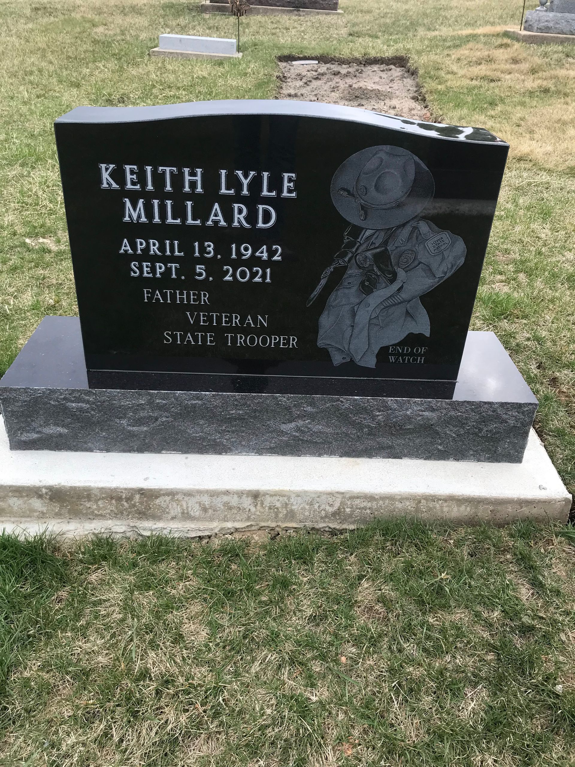 A gravestone for Keith Lyle Millard in a cemetery