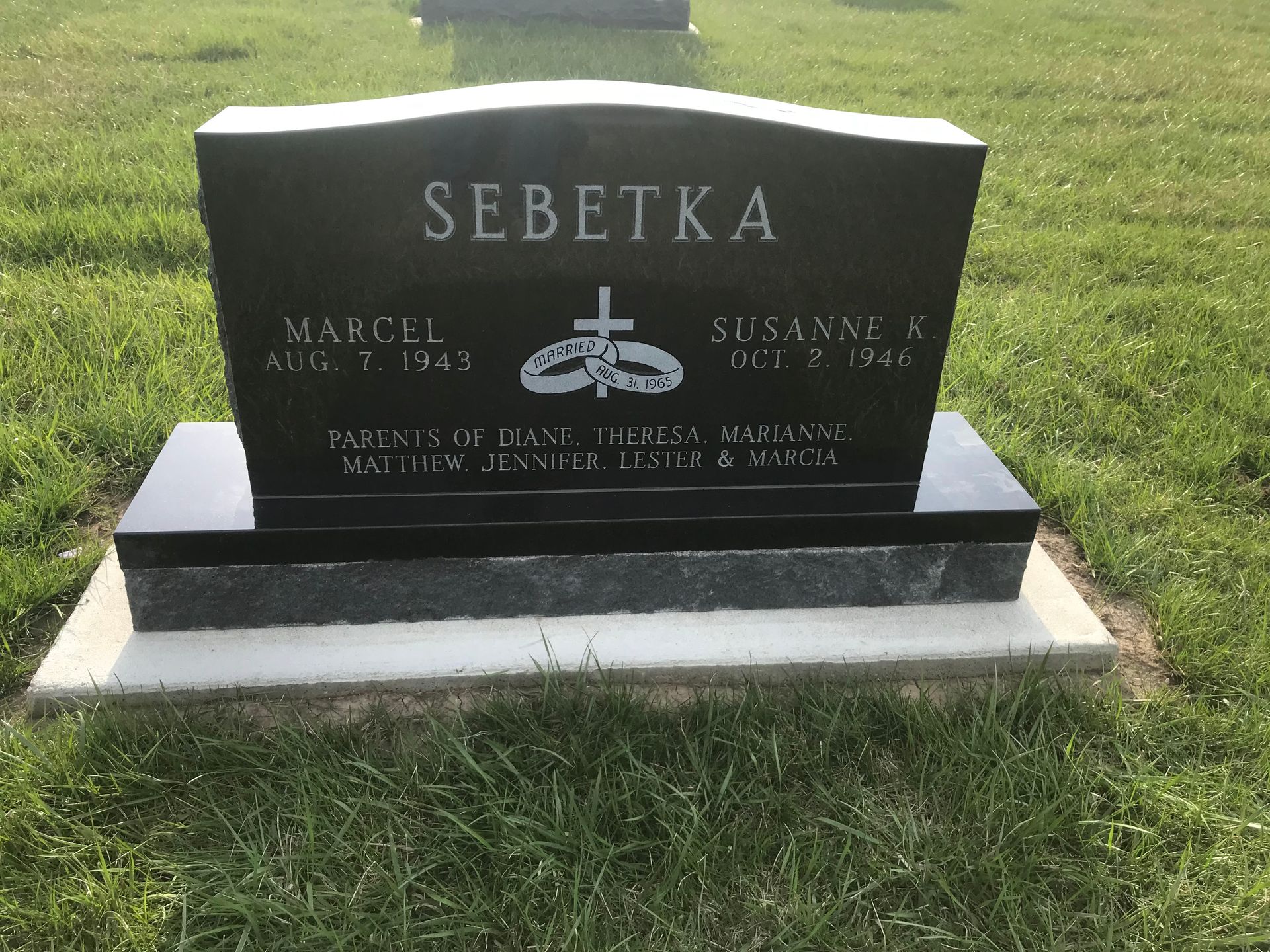 A black gravestone with the name Sebetka on it