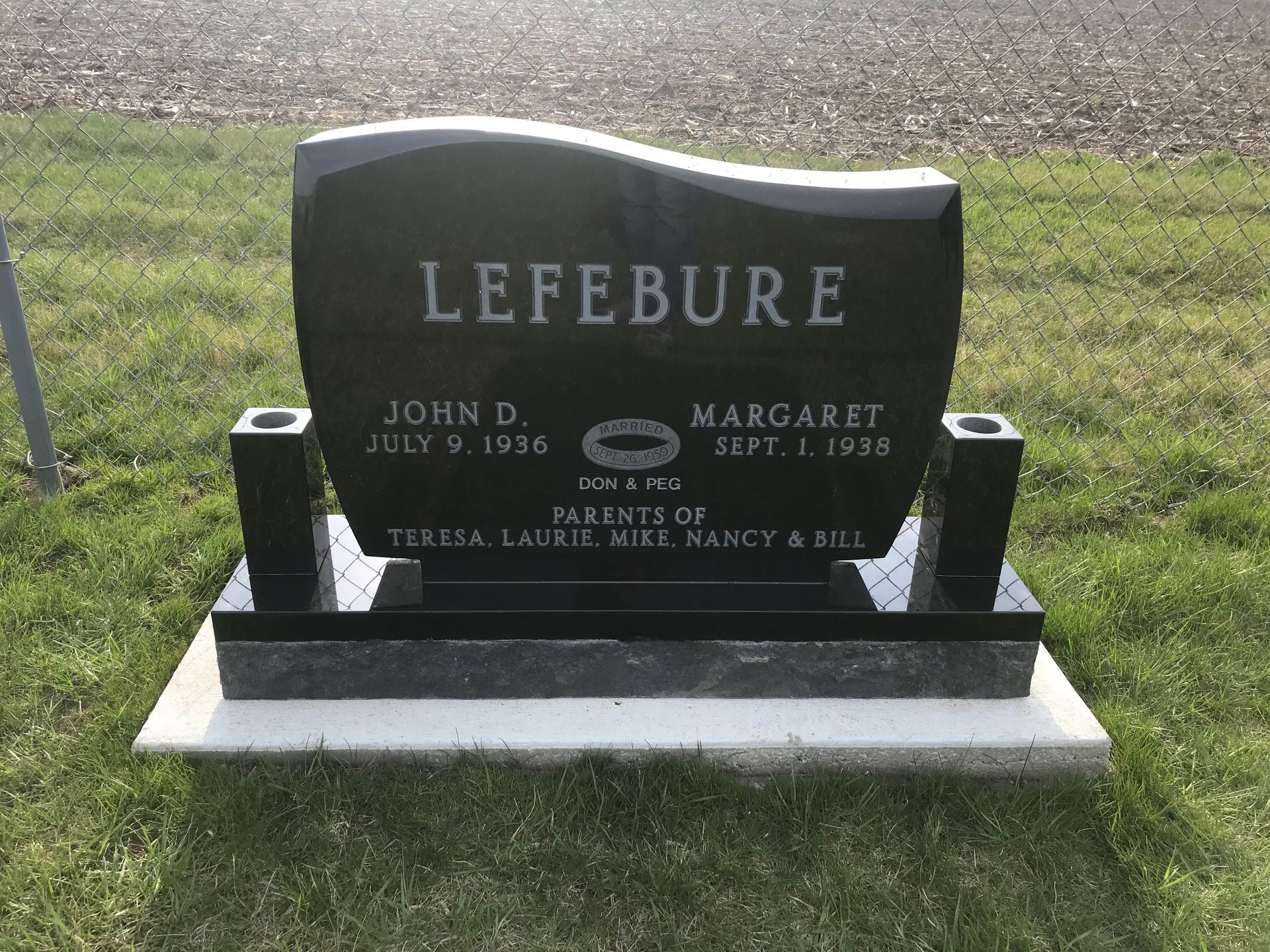 A black gravestone with the name Lefebure on it