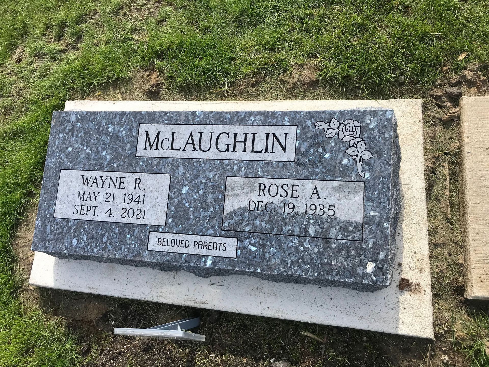 A couple of graves in a cemetery one of which is for a man named McLaughlin