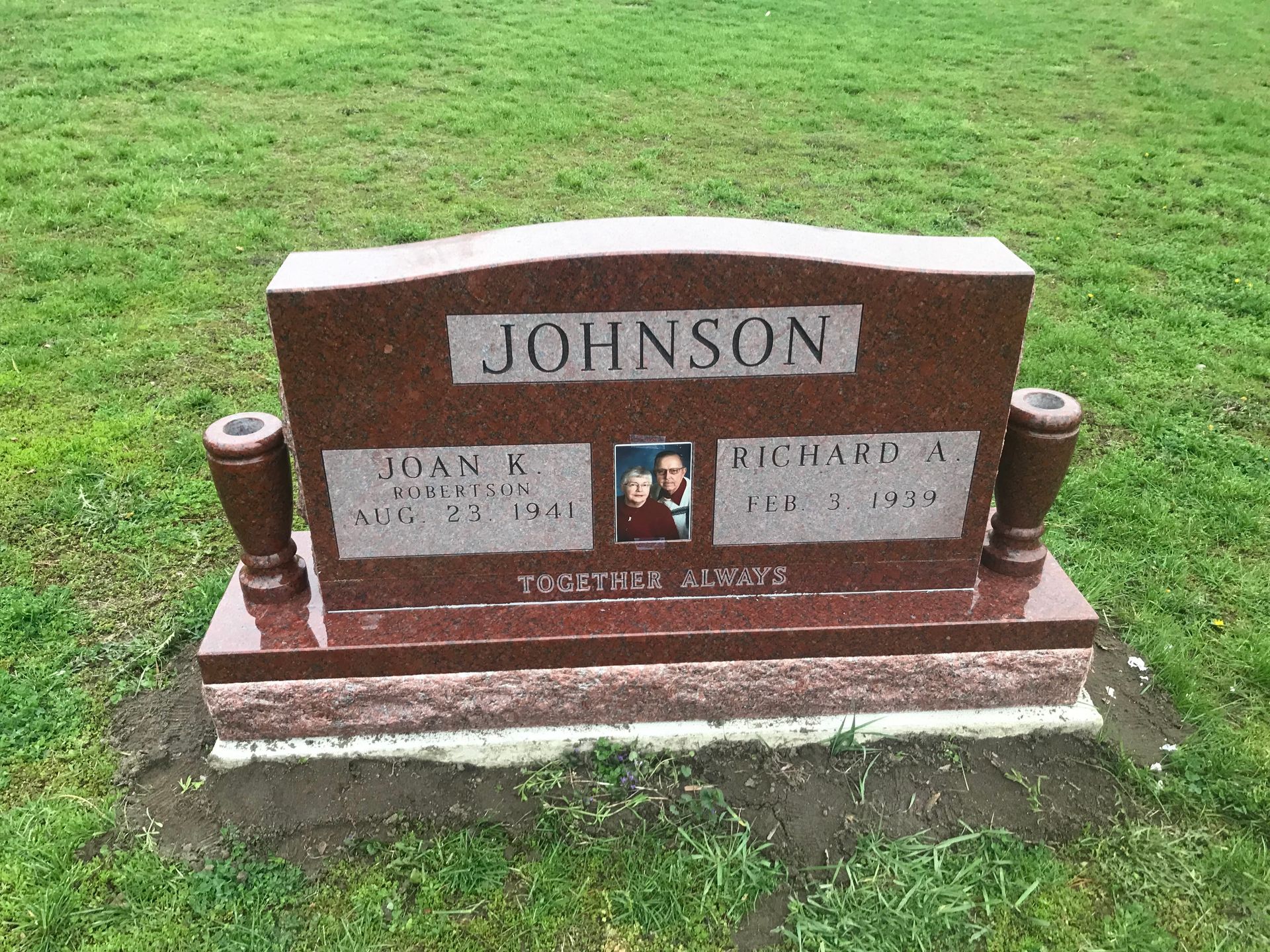 A gravestone in a cemetery with the name Johnson on it