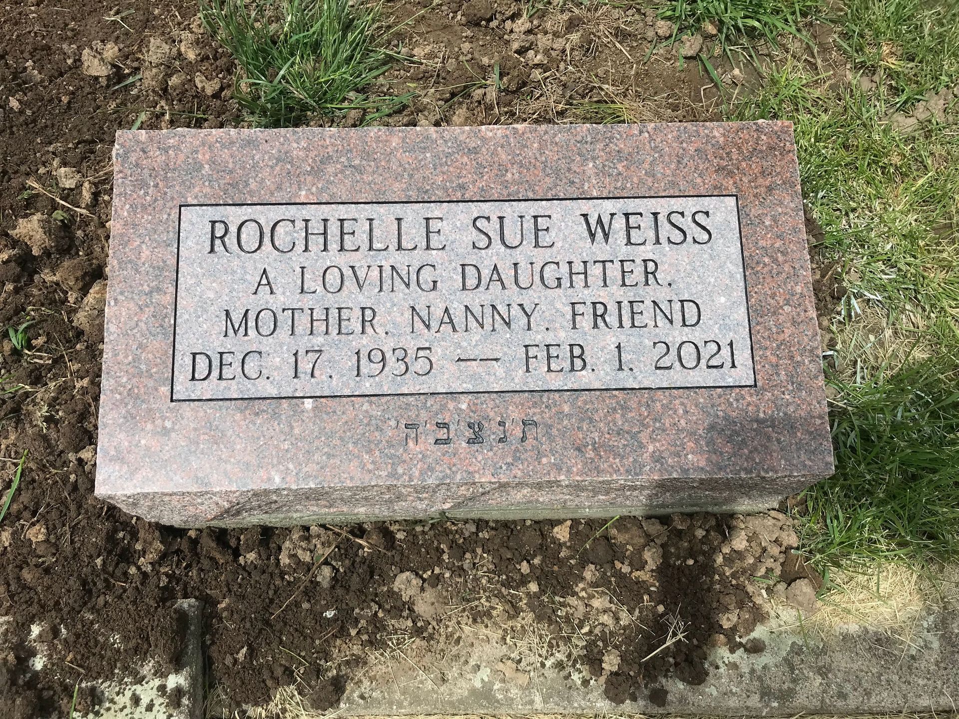 A gravestone for a mother and daughter in a cemetery.
