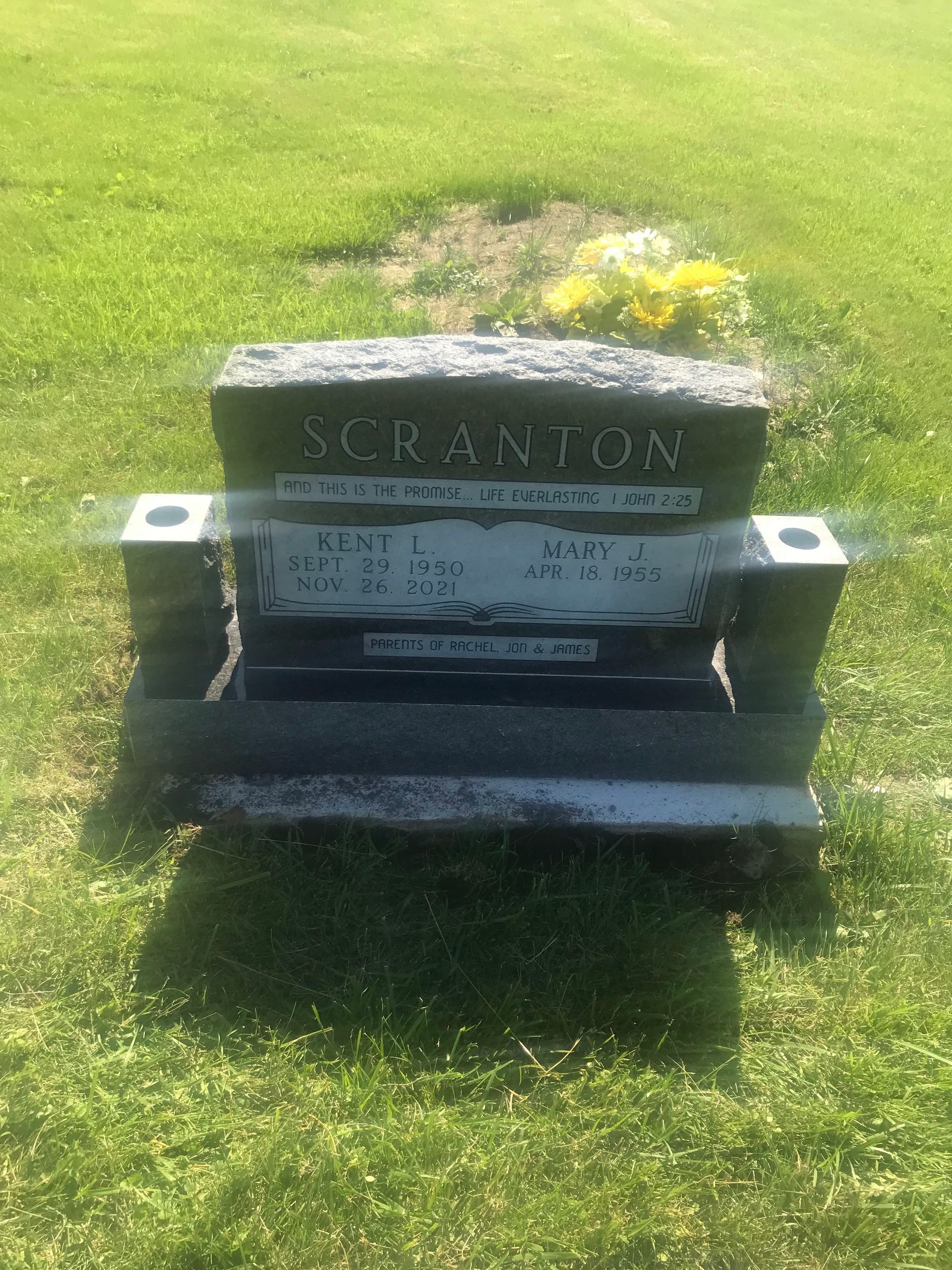 A gravestone in a cemetery that looks like a chair.