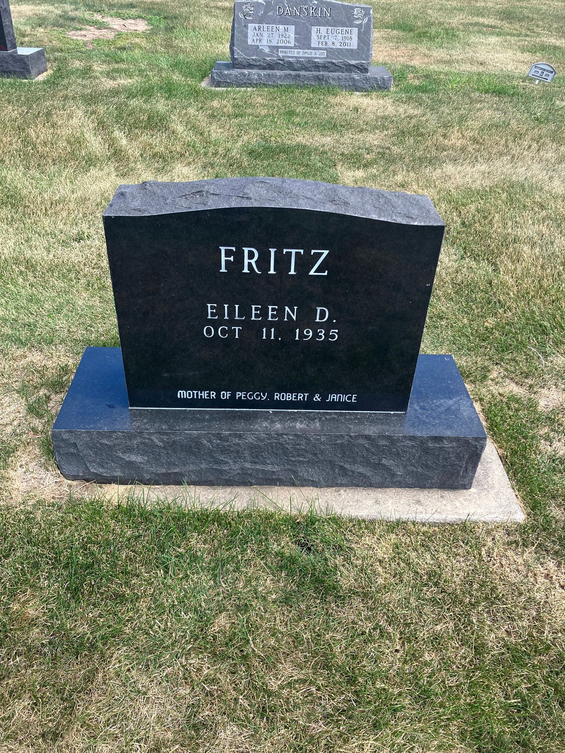 A black gravestone in a cemetery with the name Fritz written on it.