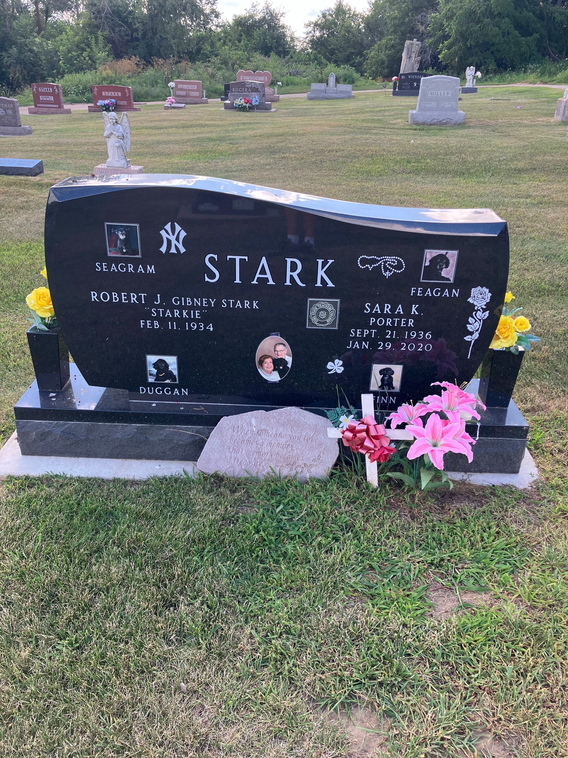 A black gravestone with the name Stark on it is in a cemetery.