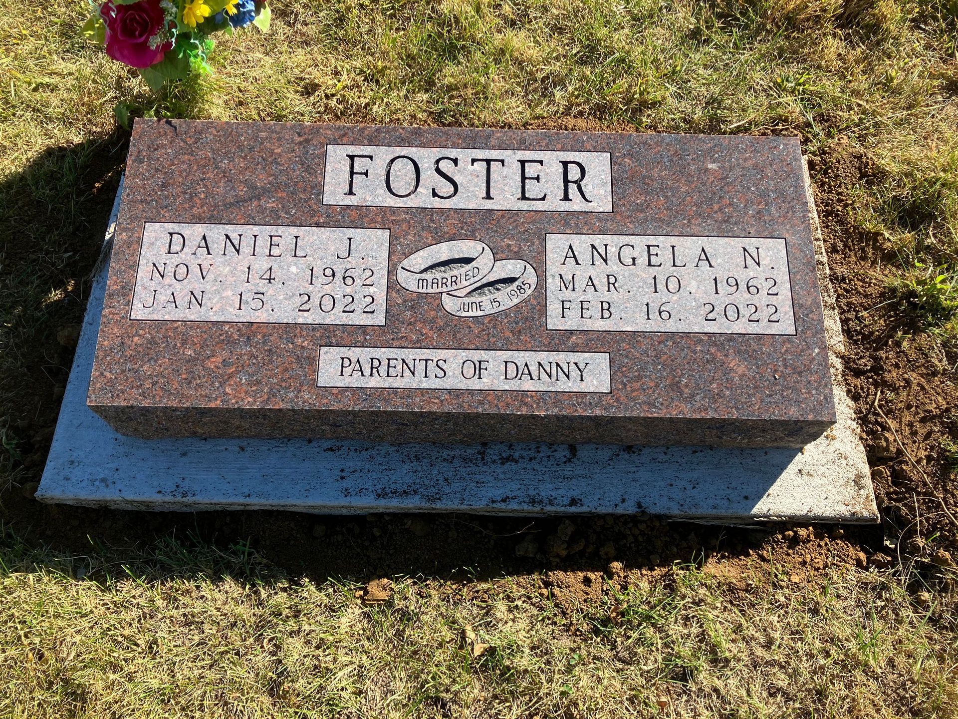 A gravestone in a cemetery with the name Foster on it