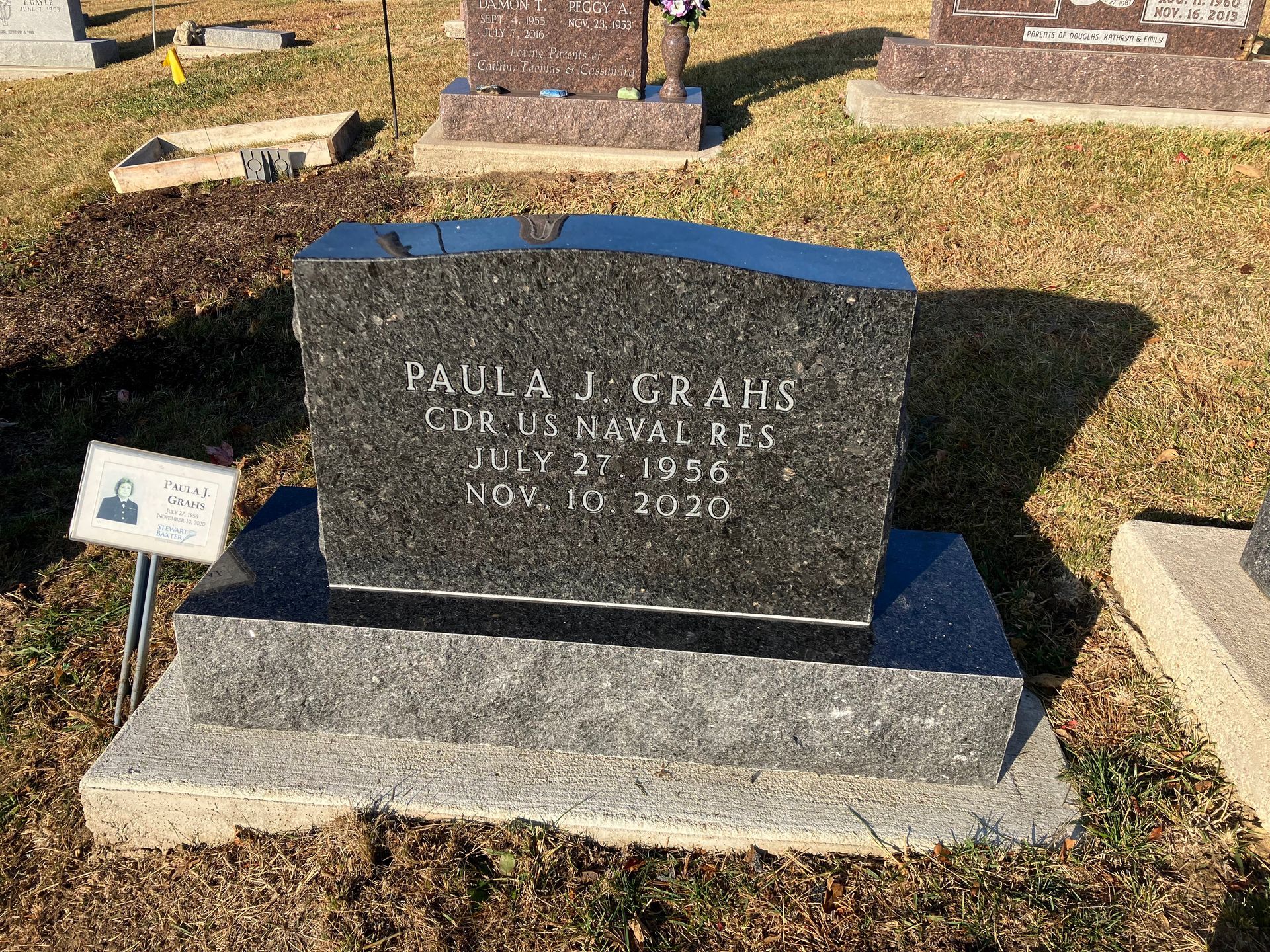 A gravestone for Paula J. Grahs is in a cemetery