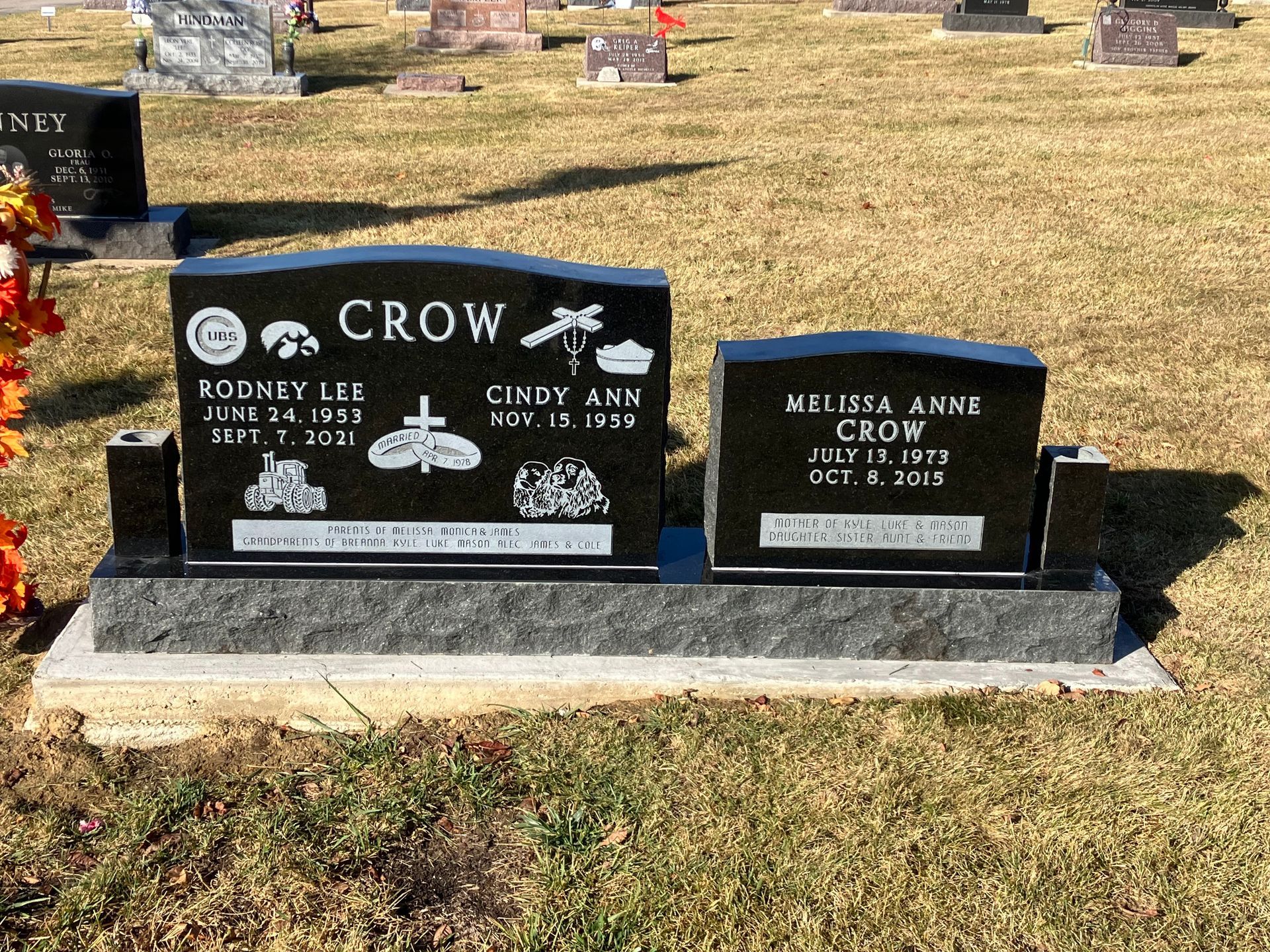 A couple of graves in a cemetery with the name crow on it