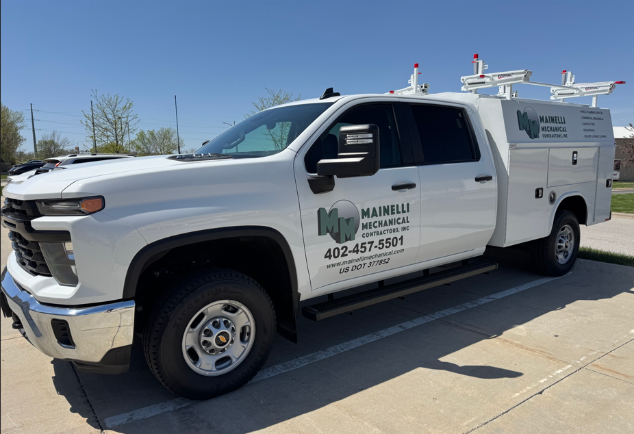 White utility truck parked outdoors.