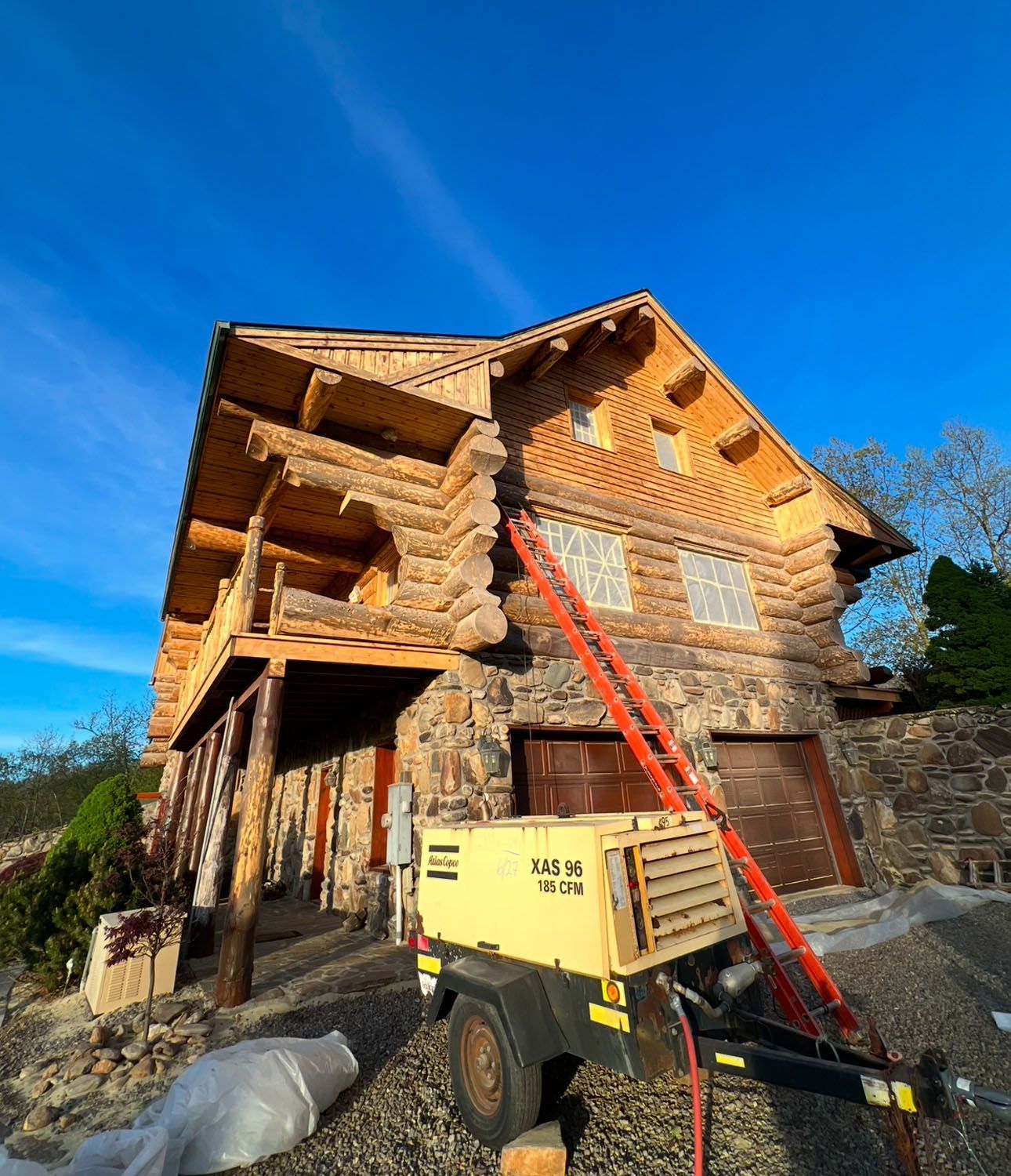 An aerial view of a log cabin with a metal roof