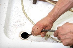 Drain being cleaned