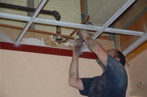 Plumber installing copper pipes in the ceiling